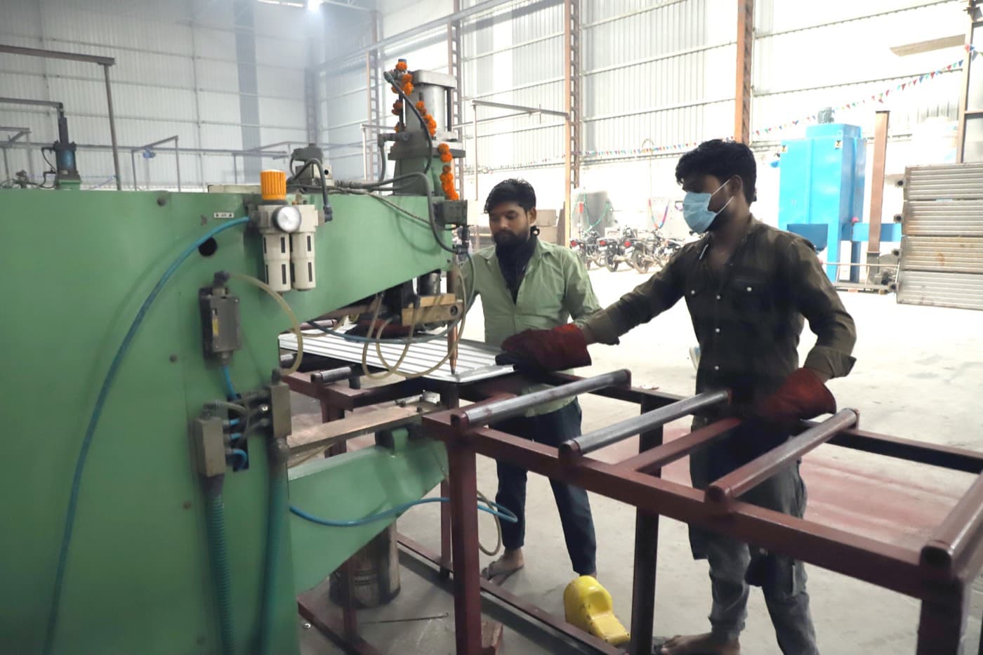 Raw steel sheet and pipe staged for inspection before forming
